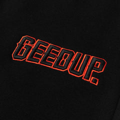 Geedup-Play-For-Keeps-EMB-Shorts-Black-Black-Orange-2024-logo-close-up